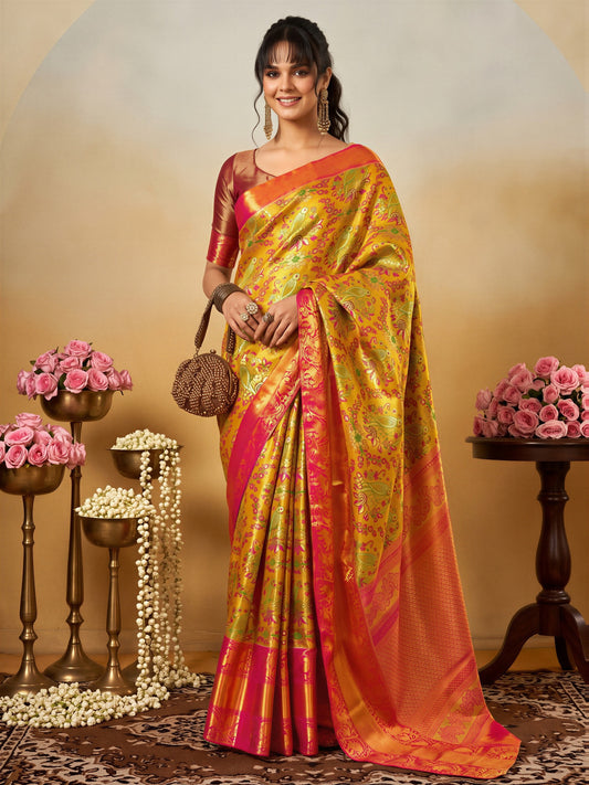 Woman wearing yellow silk blend saree with traditional indian motif work and pink blouse