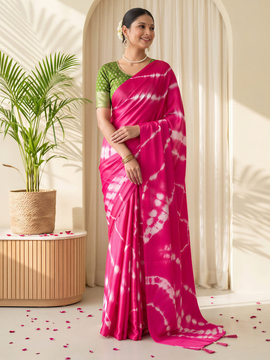 Woman wearing pink satin silk saree with tie-and-dye resist pattern and light green blouse