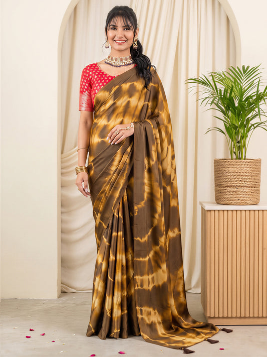 Woman wearing brown satin silk saree with tie-and-dye resist pattern and red blouse