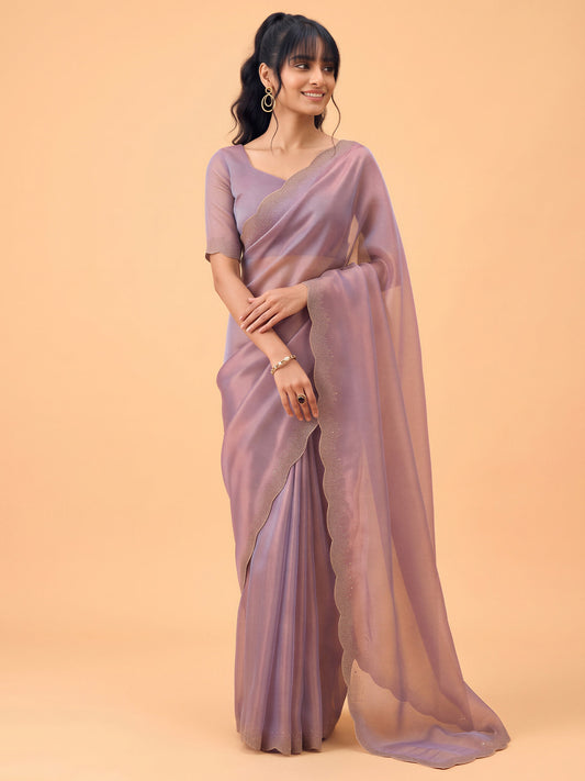 Woman wearing metallic satin silk saree with ornamented surface design and metallic blouse