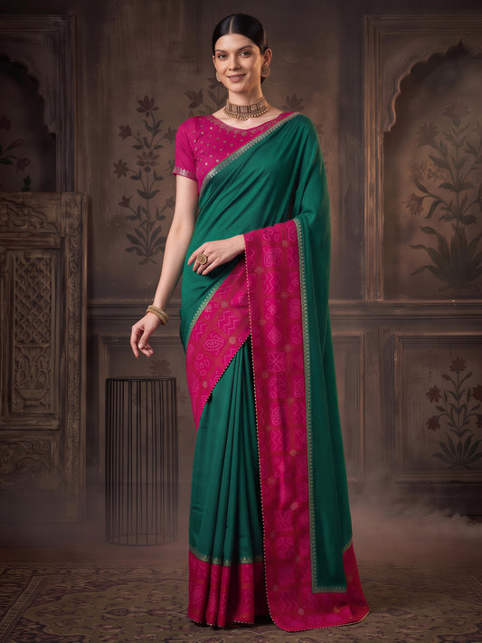 Woman wearing teal green vichitra silk saree with bandhani tie-dye dot work and pink blouse