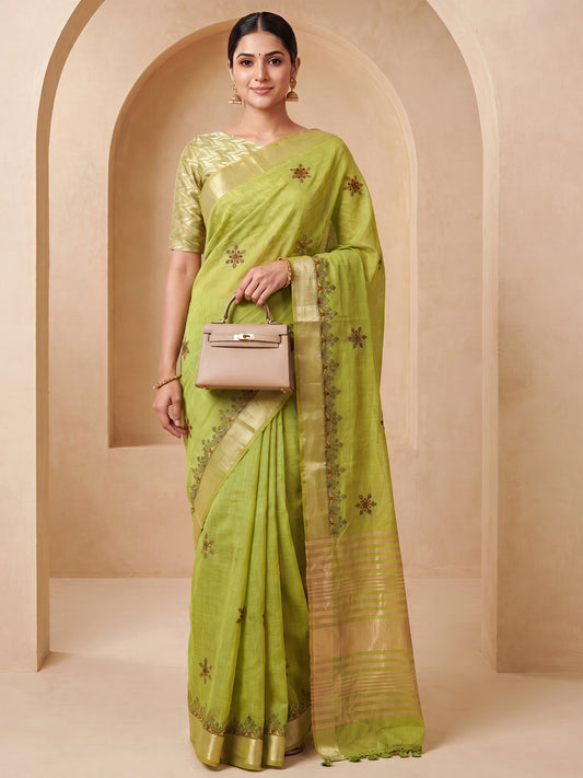 Woman wearing lime green cotton linen saree with embroidered motif work and lime green blouse