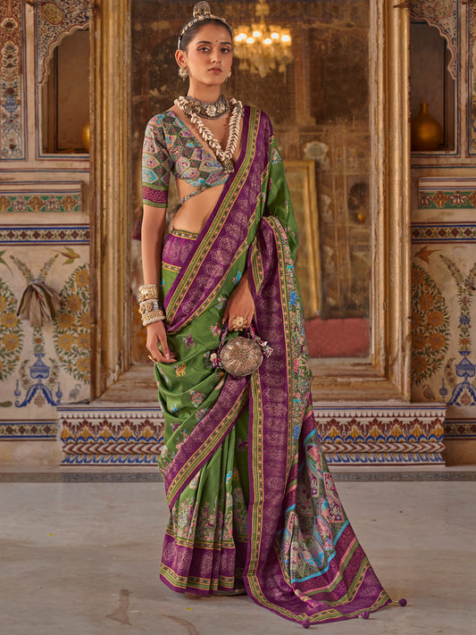 Woman wearing green silk blend saree with traditional indian motif work and multicolored blouse
