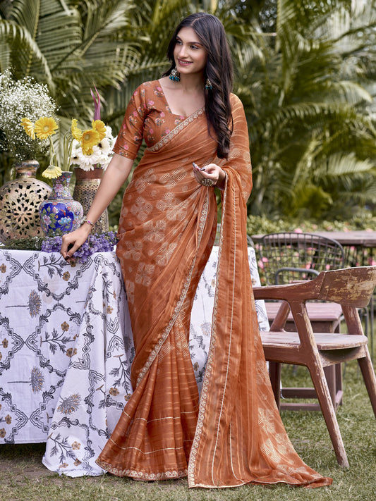 Woman wearing rust chiffon saree with traditional indian motif work and rust blouse