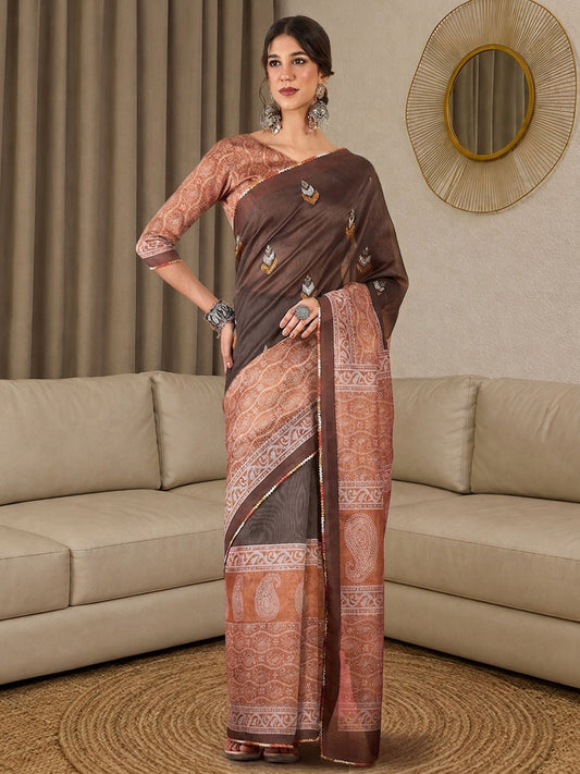 Woman wearing brown silk blend saree with all-over floral design and rust blouse