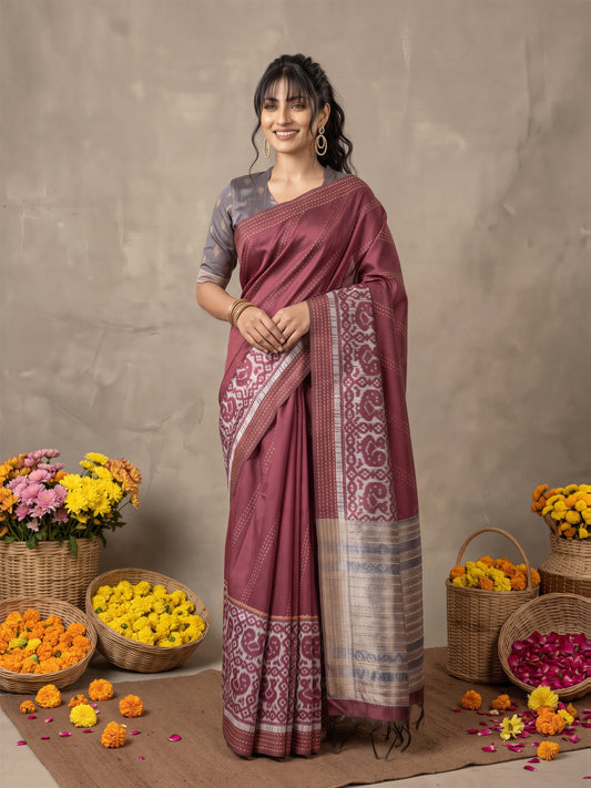 Woman wearing burgundy silk cotton saree with ikat resist-dyed pattern and grey blouse