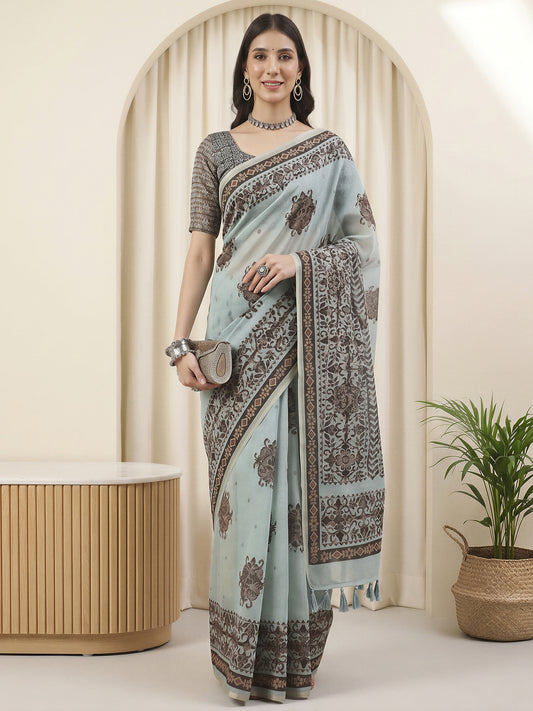 Woman wearing light blue cotton linen saree with hand block-printed motifs and light blue blouse