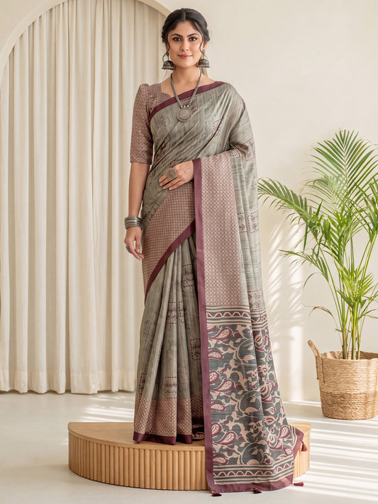 Woman wearing light green silk blend saree with traditional indian motif work and beige blouse