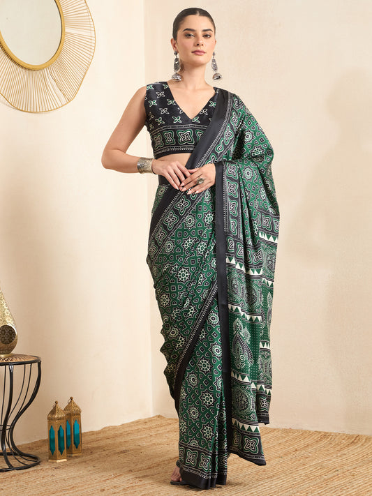 Woman wearing green crepe saree with ajrak block-print motif work and black blouse