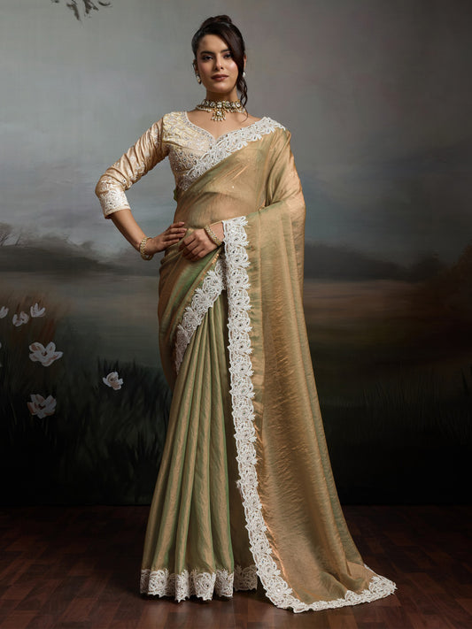 Woman wearing beige satin silk saree with clean solid-tone finish and beige blouse