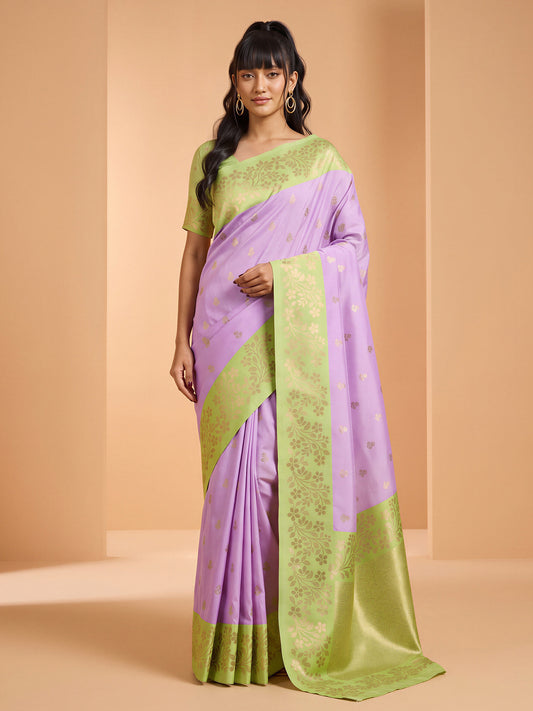 Woman wearing purple cotton blend saree with all-over floral design and sea green blouse