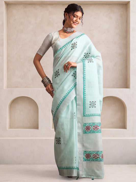 Woman wearing mint green linen saree with bagh block-print motif work and mint green blouse