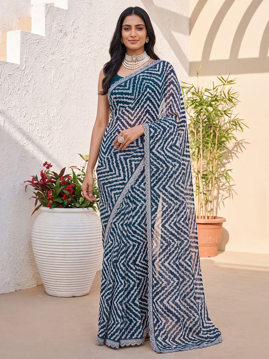 Woman wearing teal blue georgette saree with geometric pattern design and teal blue blouse