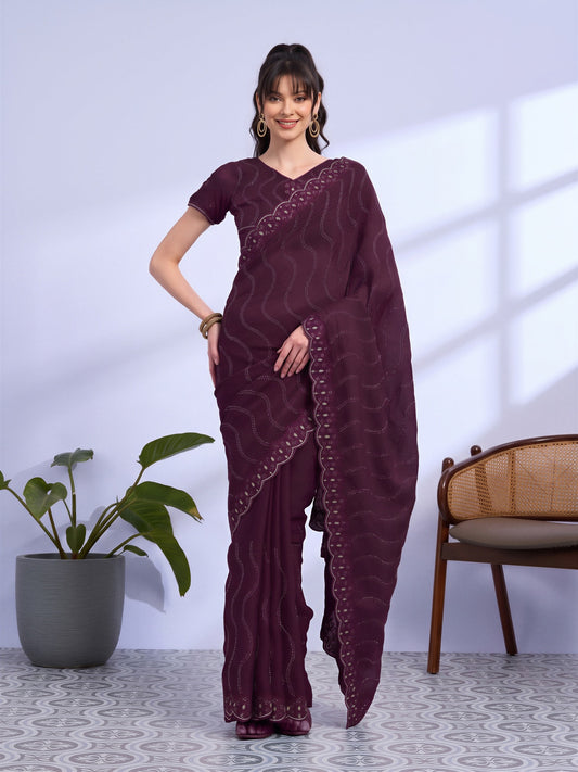 Woman wearing wine tissue saree with geometric pattern design and wine blouse