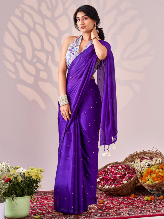 Woman wearing purple chiffon saree with ornamented surface design and lavender blouse