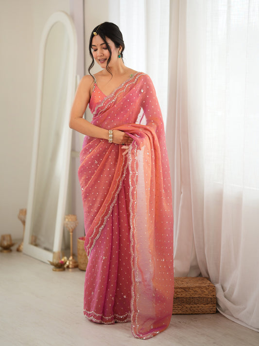 Woman wearing pink georgette saree with zari butta (metallic motif) work and pink blouse