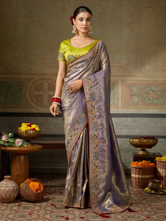 Woman wearing lavender silk blend saree with ornamented surface design and lime green blouse