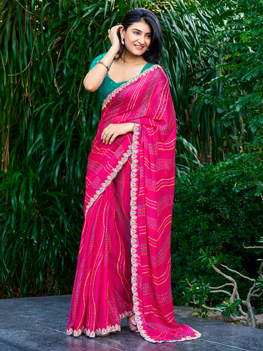 Woman wearing pink georgette saree with striped pattern design and teal green blouse