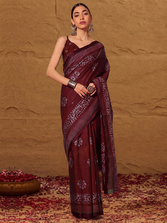 Woman wearing maroon cotton saree with batik wax-resist design and maroon blouse