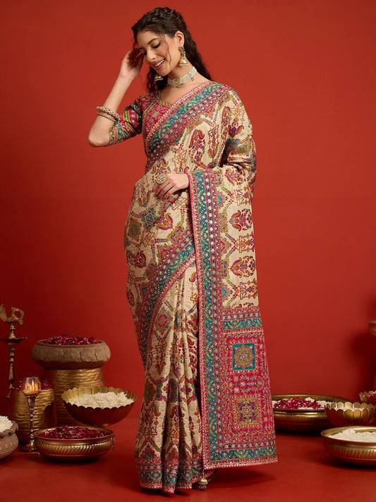 Woman wearing cream silk blend saree with traditional indian motif work and pink blouse