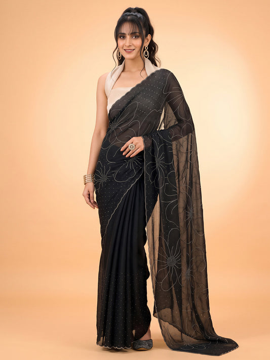 Woman wearing black satin silk saree with ornamented surface design and white blouse