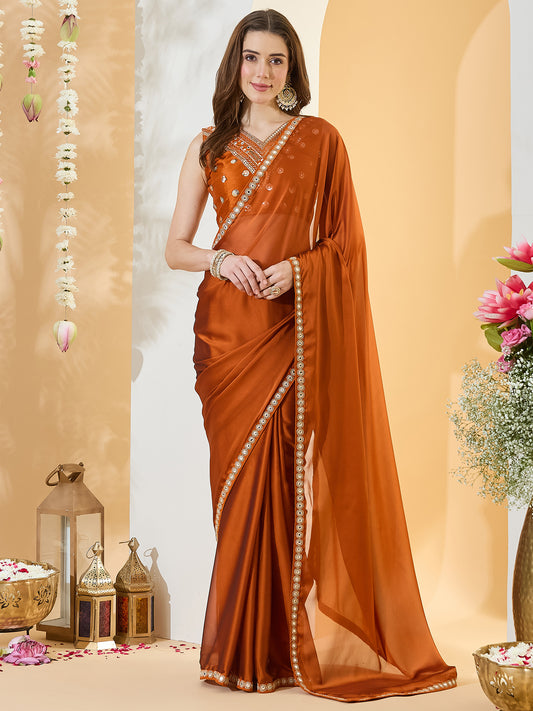 Woman wearing rust pure georgette saree with clean solid-tone finish and rust blouse