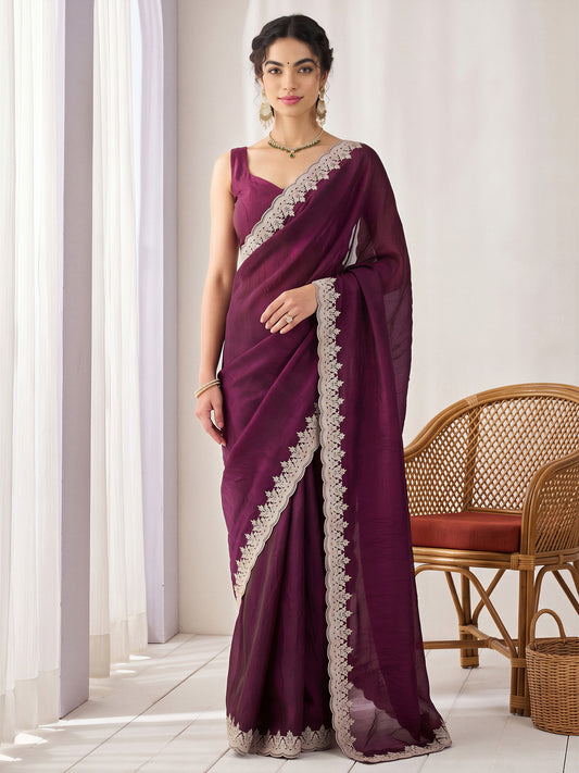 Woman wearing wine satin saree with clean solid-tone finish and wine blouse