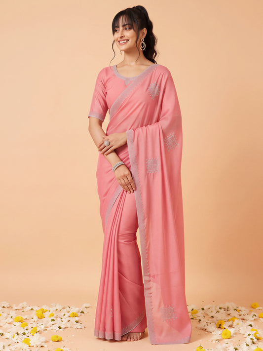 Woman wearing pink georgette saree with ornamented surface design and pink blouse