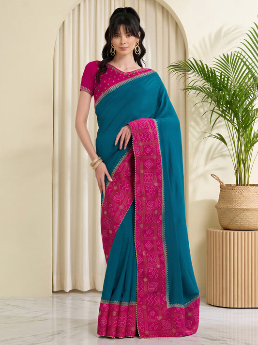 Woman wearing teal blue vichitra silk saree with bandhani tie-dye dot work and pink blouse
