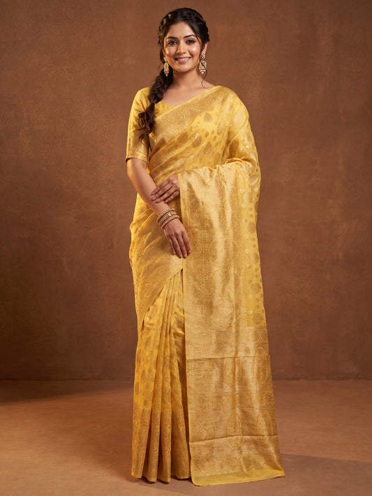 Woman wearing yellow silk blend saree with zari butta (metallic motif) work and yellow blouse