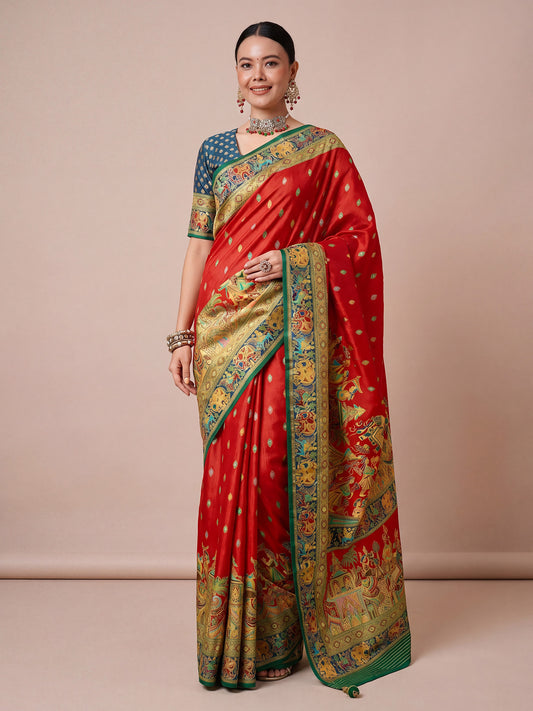 Woman wearing red viscose saree with metallic foil print work and teal blue blouse
