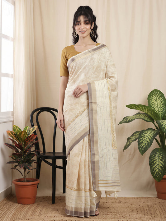 Woman wearing off white cotton silk saree with ornamented surface design and mustard blouse