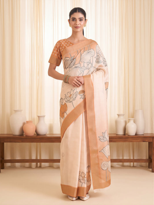 Woman wearing white satin silk saree with traditional indian motif work and orange blouse