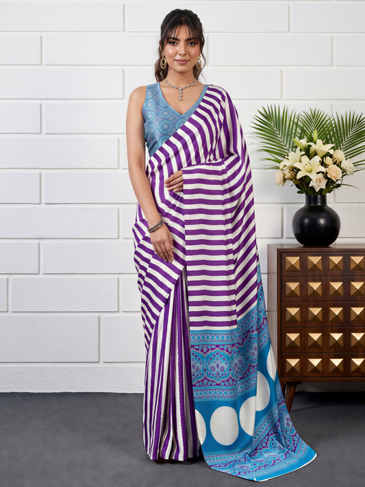 Woman wearing purple satin saree with striped pattern design and light blue blouse