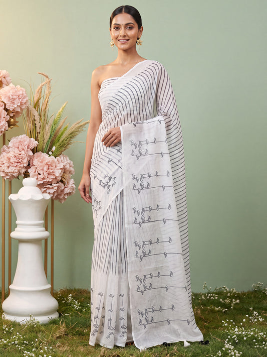 Woman wearing white cotton linen saree with striped pattern design and white blouse