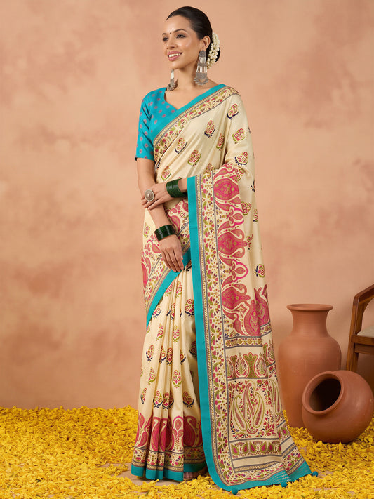 Woman wearing off white silk blend saree with metallic foil print work and teal blue blouse