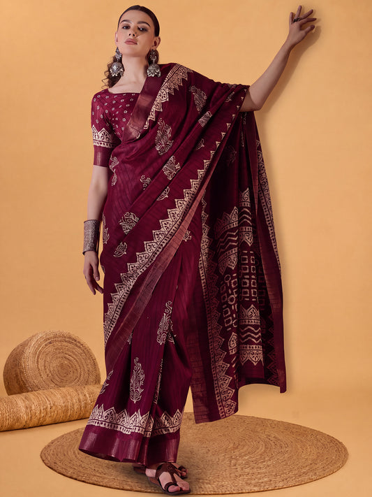 Woman wearing burgundy silk blend saree with dabu mud-resist print work and burgundy blouse