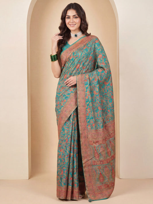 Woman wearing light blue dola silk saree with traditional indian motif work and light blue blouse