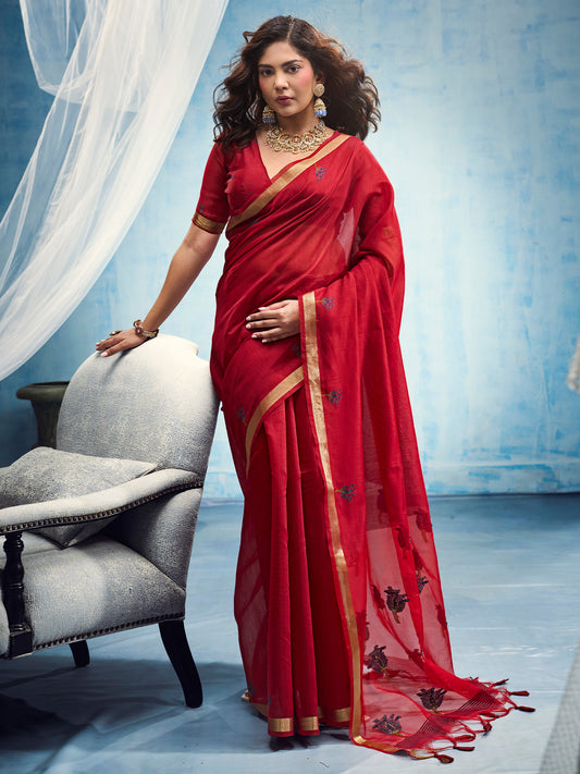 Woman wearing red muga cotton saree with embroidered motif work and red blouse