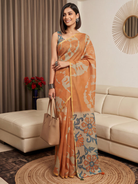 Woman wearing rust cotton blend saree with shibori resist-dye pattern and teal blue blouse