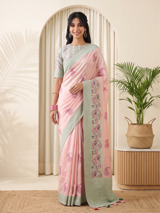 Woman wearing pink silk blend saree with traditional indian motif work and light green blouse
