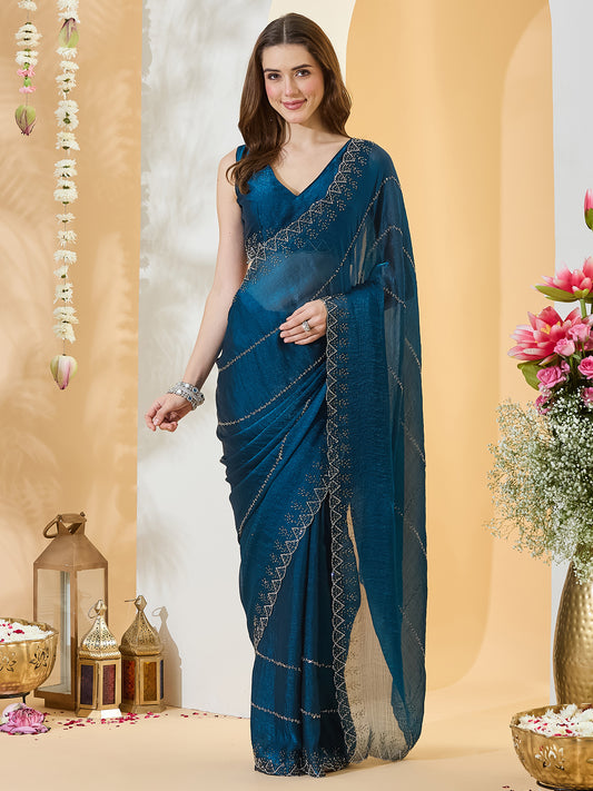 Woman wearing navy blue chiffon saree with ornamented surface design and navy blue blouse