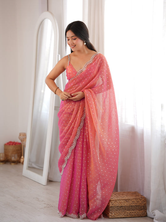 Woman wearing pink silk blend saree with ornamented surface design and pink blouse