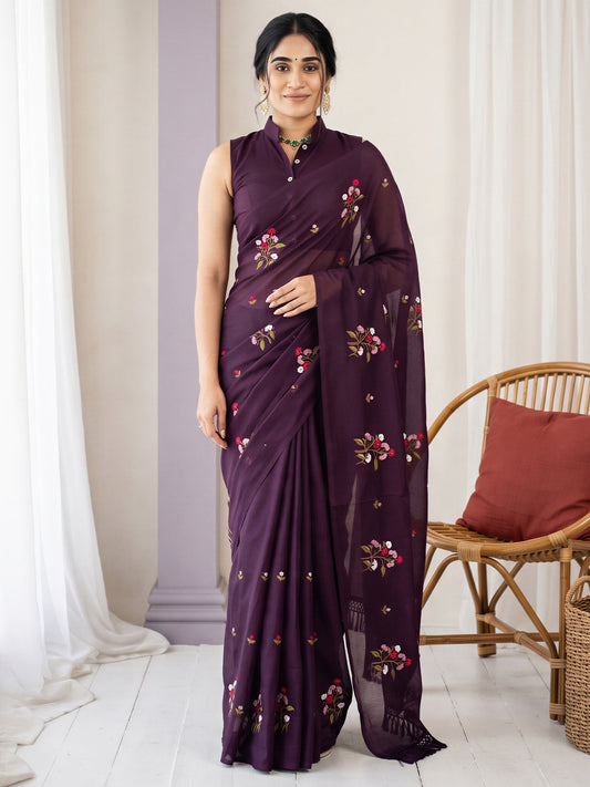 Woman wearing wine kota doria cotton saree with embroidered motif work and wine blouse
