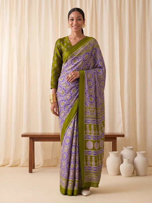 Woman wearing purple crepe saree with ajrak block-print motif work and olive blouse