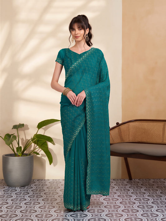 Woman wearing teal green tissue saree with geometric pattern design and teal green blouse