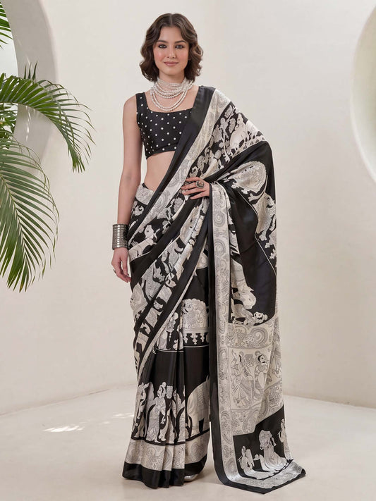 Woman wearing black crepe saree with kalamkari narrative motif work and black blouse