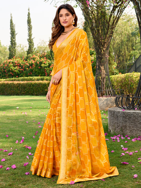 Woman wearing yellow chiffon saree with metallic foil print work and yellow blouse