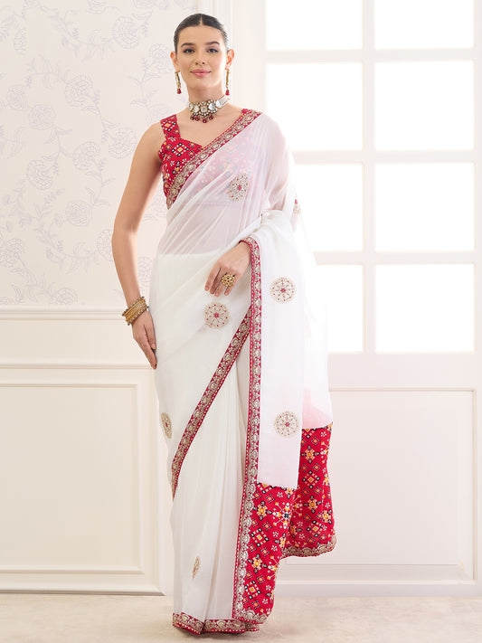 Woman wearing white viscose saree with zari butta (metallic motif) work and red blouse