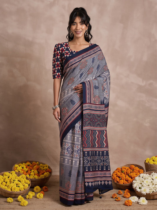 Woman wearing grey viscose silk saree with traditional indian motif work and navy blue blouse